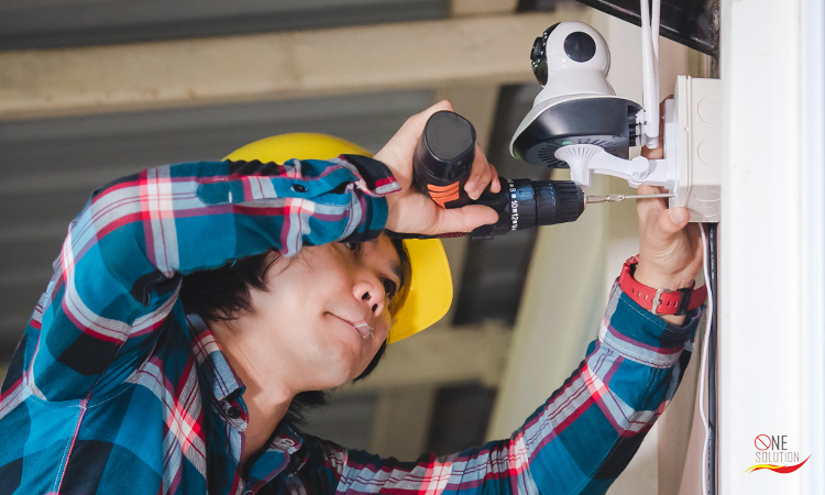 Person installing a CCTV camera